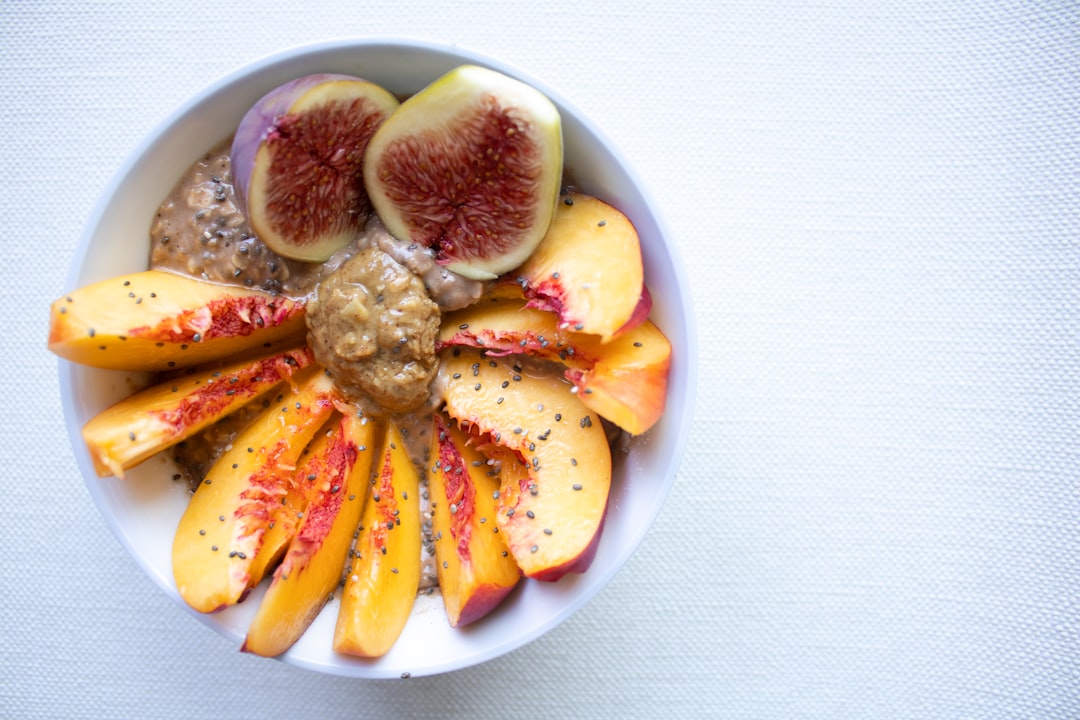 a white bowl filled with sliced fruit on top of a table - Anti-Inflammatory Foods