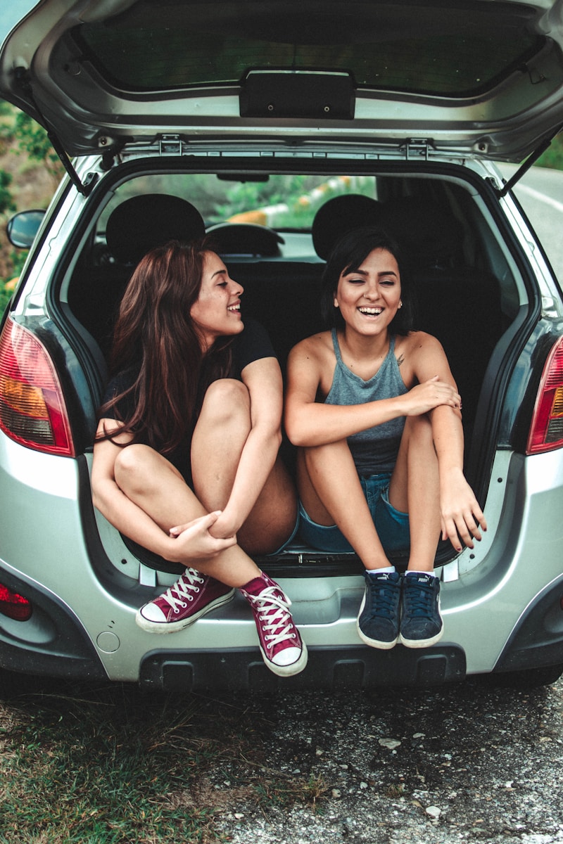 two women sitting at the back of the car Car Mold