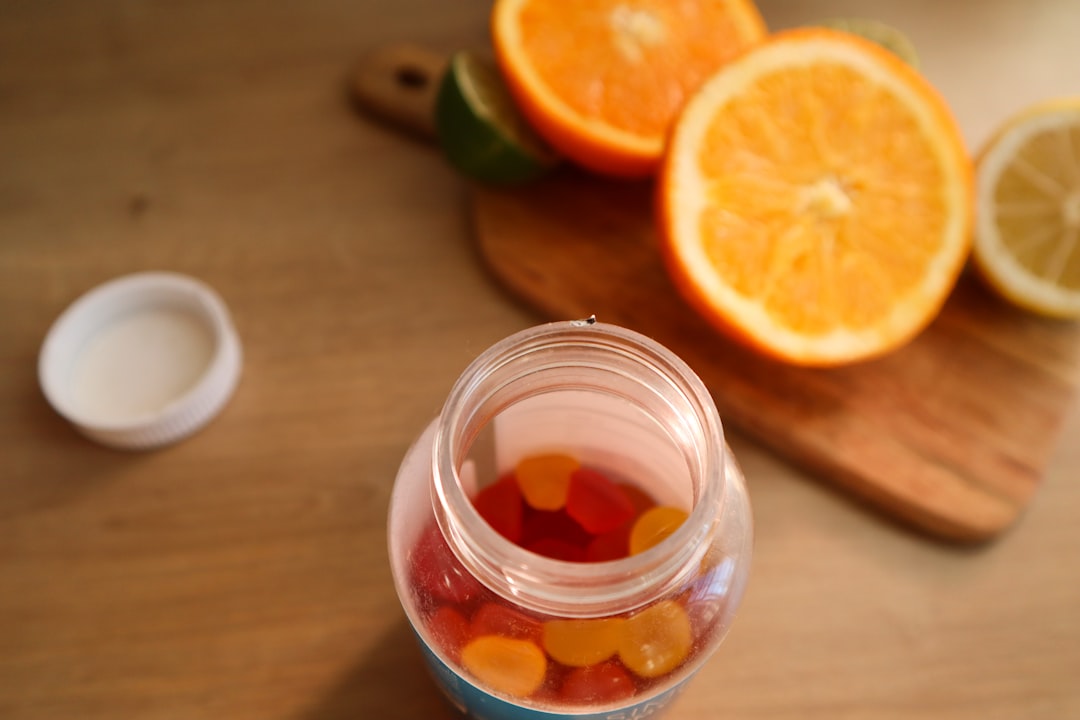 a jar filled with gummy bears next to sliced oranges- Vitamin D and Mental Health