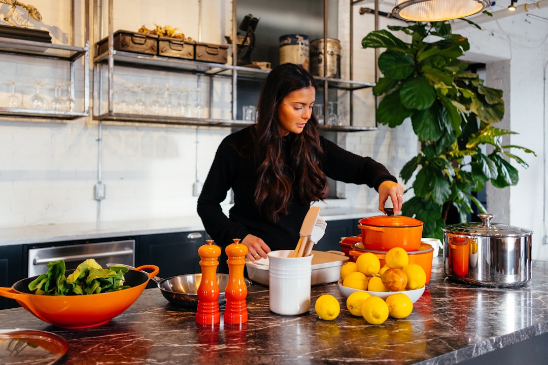 woman standing in front of fruits holding pot's lid - Anti-Inflammatory Foods