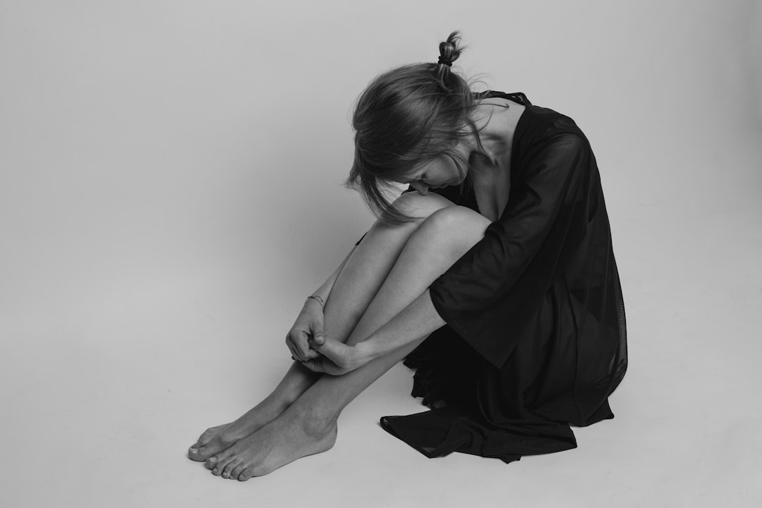 woman in black dress sitting on floor- Power of Quality Sleep