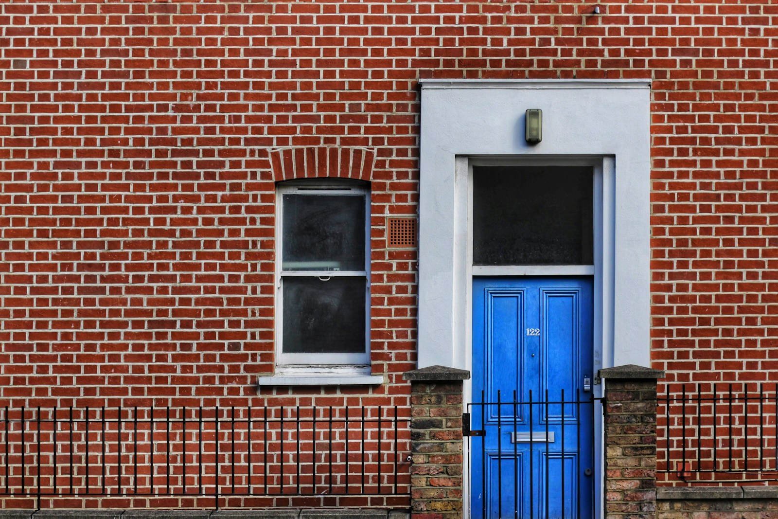 red brick building with closed door and window Mold in Rental Properties