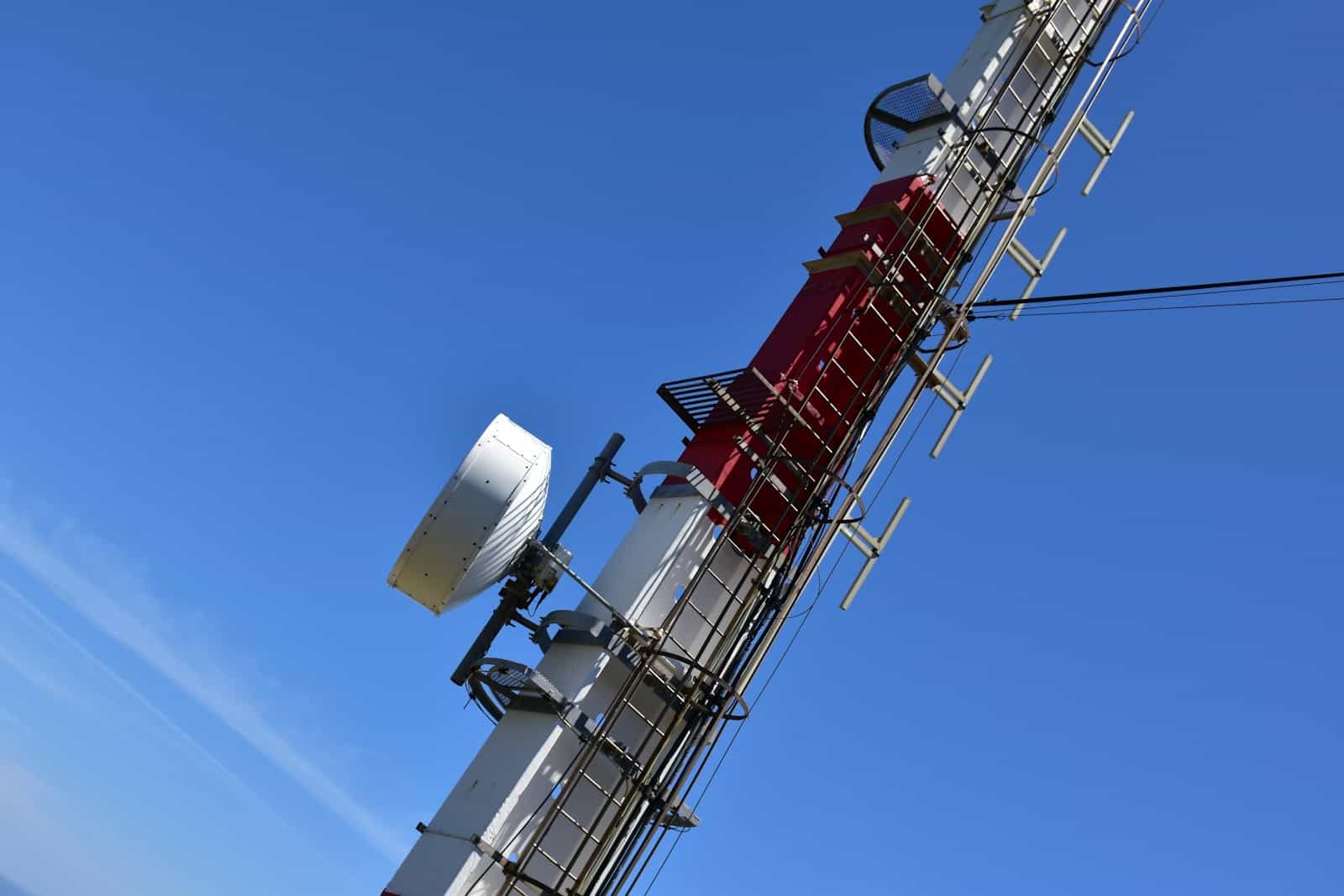 a cell phone tower with a lot of antennas on top of it Reducing EMFs