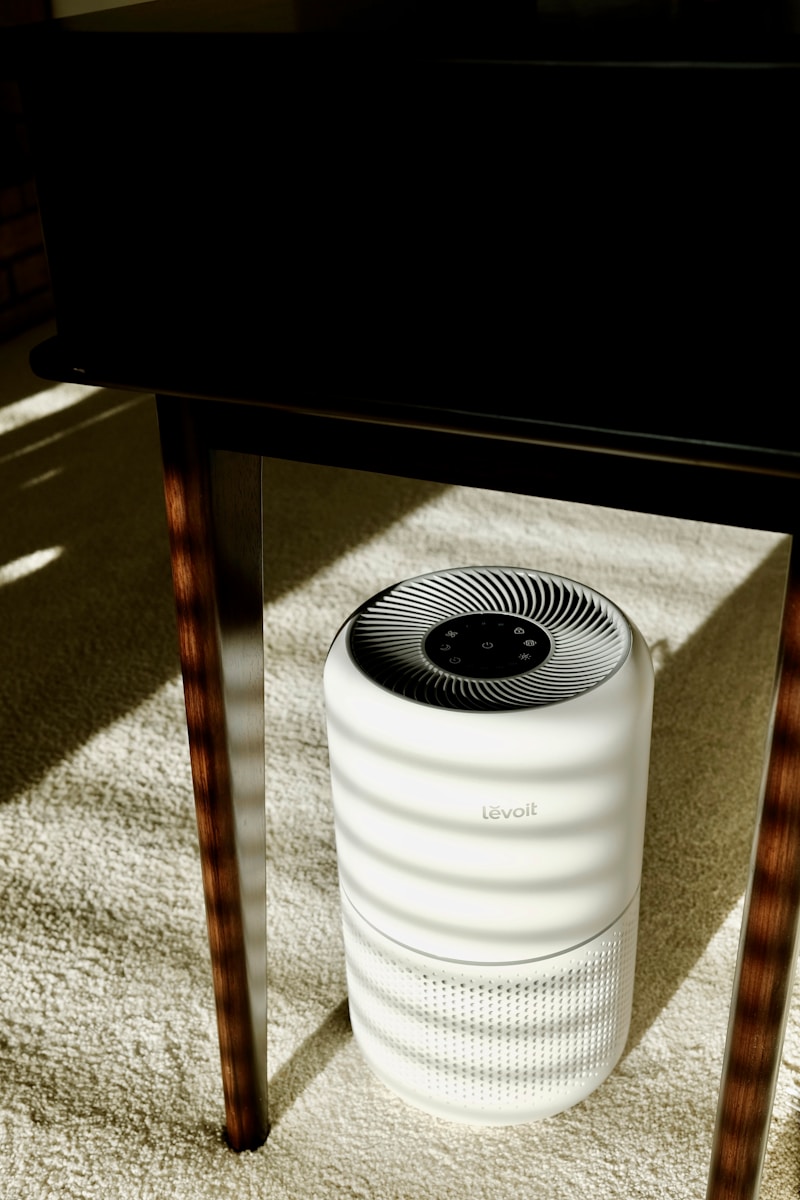 a white air conditioner sitting under a table Mold at the Source