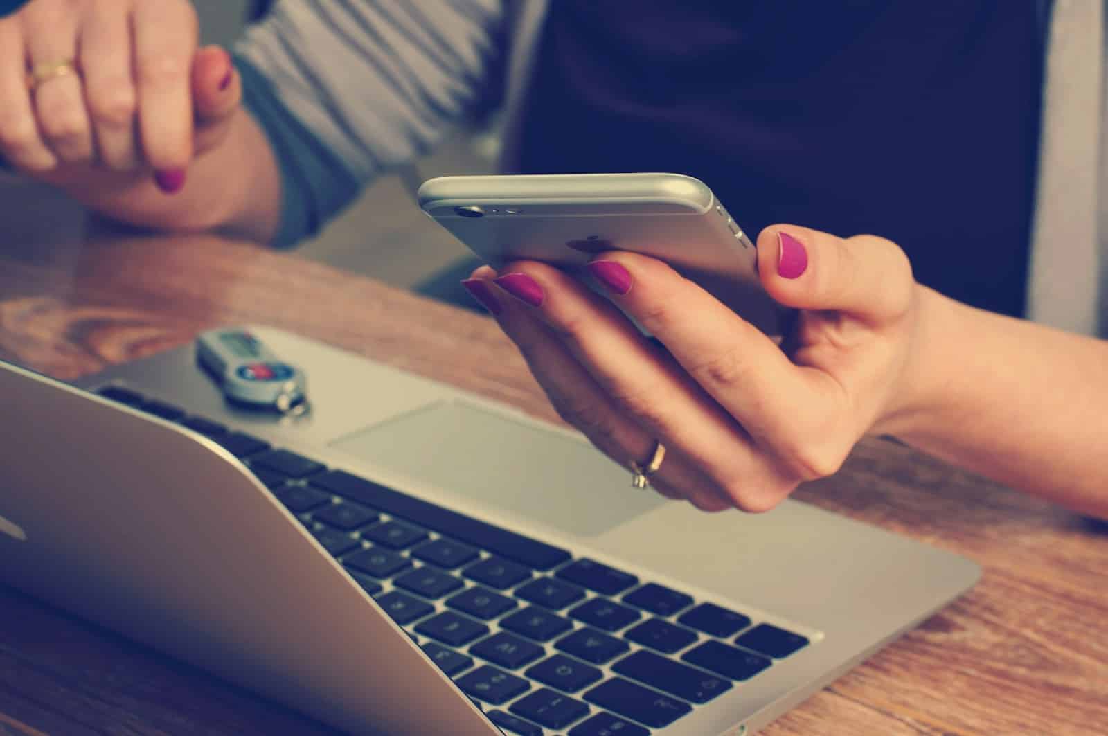 woman holding silver iPhone 6 Reducing EMFs