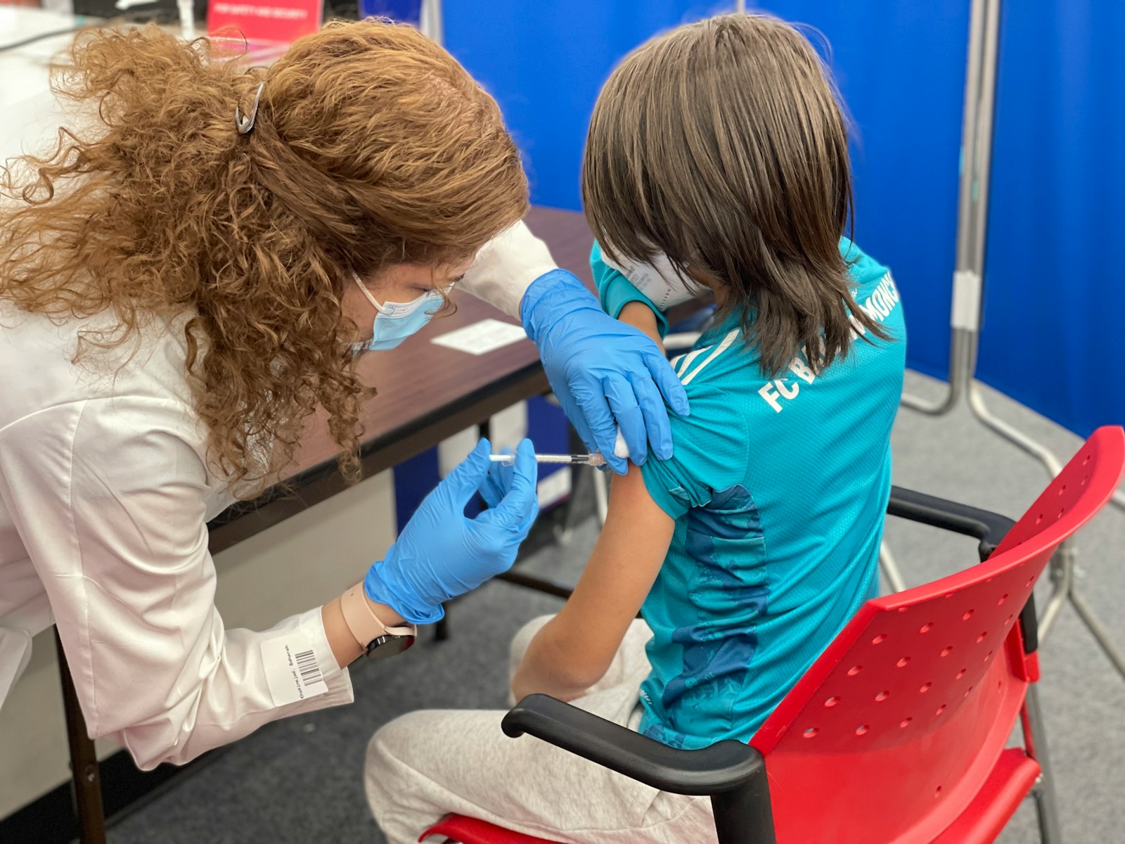 a woman getting her teeth checked by a doctor Vaccine for Kids