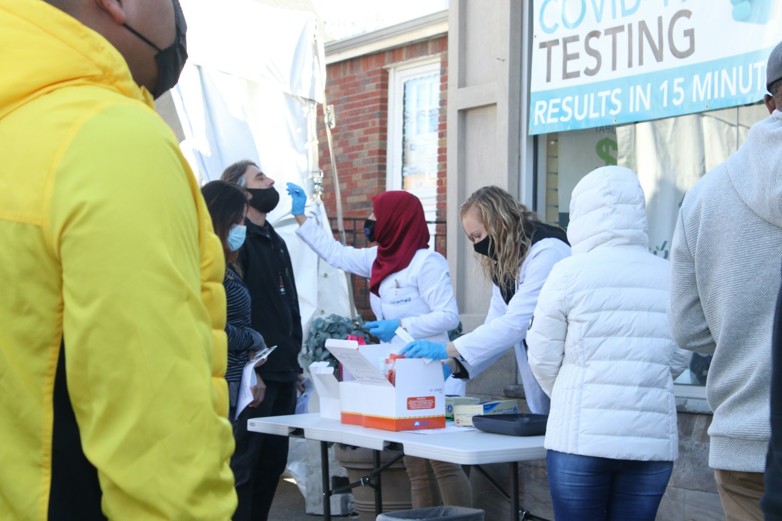 people standing near white table during daytime inflammation